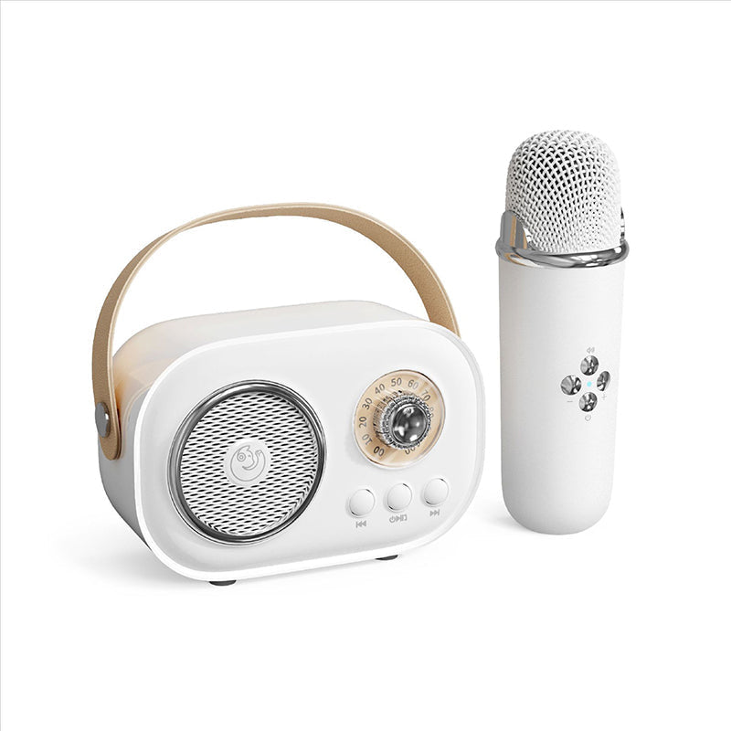 Kids' karaoke speaker and wireless microphone, displayed on a tabletop, ready for fun and entertainment.
