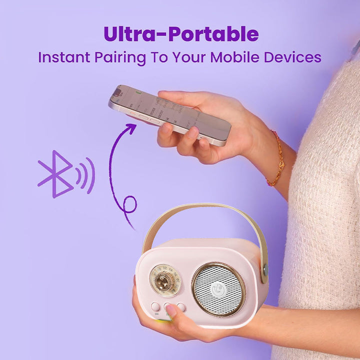 Wireless microphone for kids' karaoke speaker, silver, held by a child's hand, enhancing musical play.