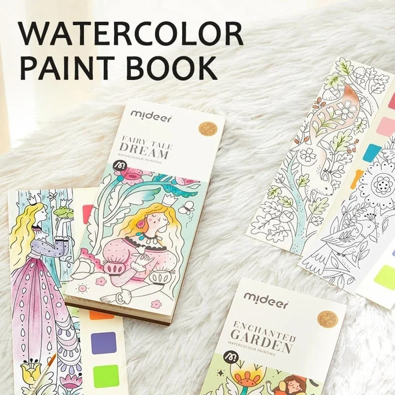 Toddler holding mini watercolor painting book, expressing joy while painting