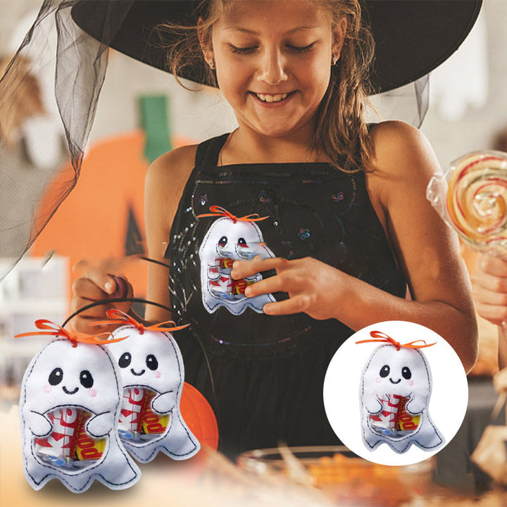 Close-up of a child's hand holding a ghost-shaped Halloween candy bag, perfect for trick-or-treating