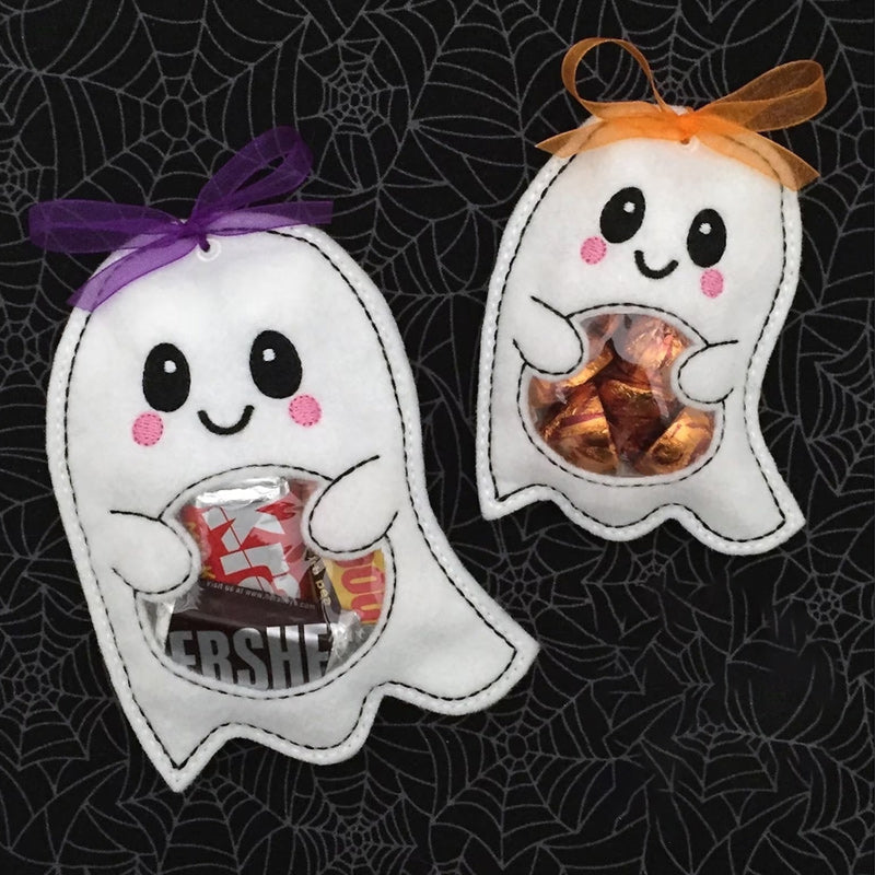 Kids' Halloween party table adorned with various spooky ghost and pumpkin treat bags