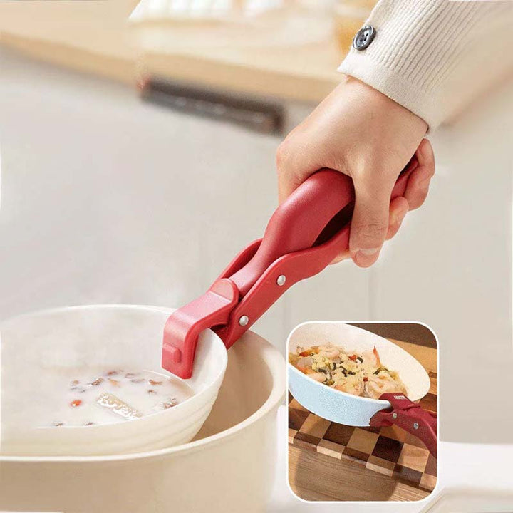 A hand demonstrating the safe use of a kitchen anti-scald bowl clip on a hot casserole dish.