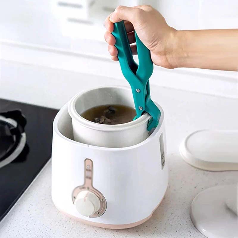 Stainless steel anti-scald bowl clip with a black handle, designed for safe handling of hot dishes.