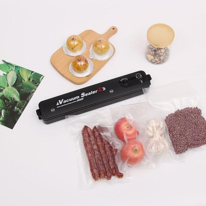 Electric vacuum sealer in action, demonstrating its food preservation capabilities.