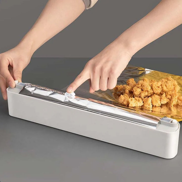 Close-up of a kitchen wrap dispenser showcasing the smooth precision cutting mechanism for foil and film.
