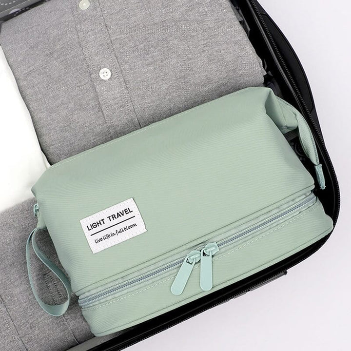 Open travel toiletry bag filled with travel-sized bottles, highlighting its organizer features and functionality.