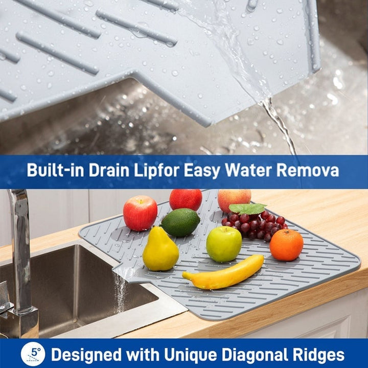 Overview of a clean kitchen counter with a green silicone dish drying mat, ready for use, simple kitchen solution
