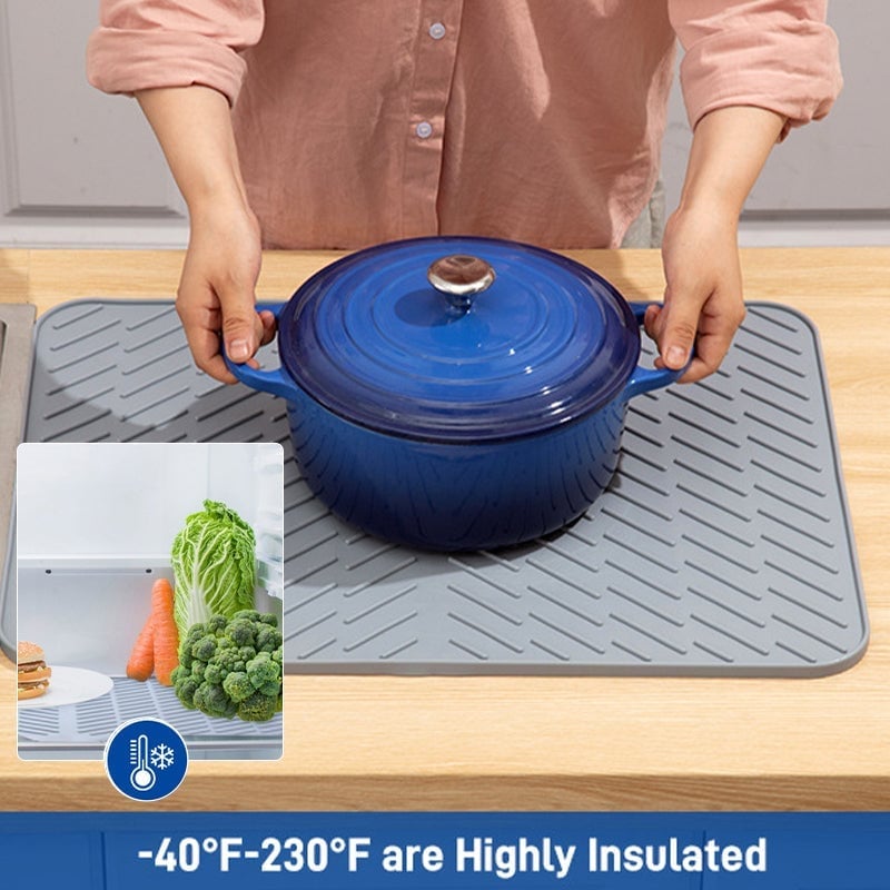 Rolled-up black silicone dish drying mat, demonstrating its space-saving storage, heat resistant kitchen tool