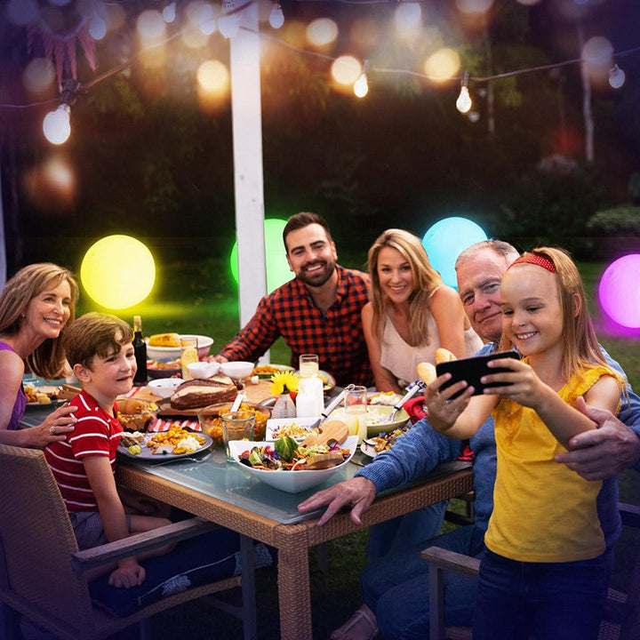 Kids laughing and playing with an inflatable LED light-up beach ball