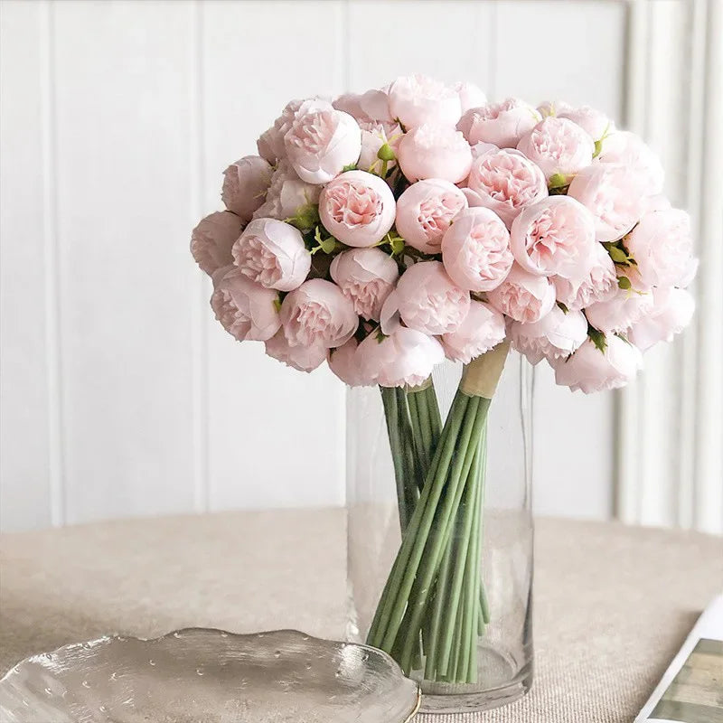 Delicate faux peony bouquet with lush leaves, ready to be a charming bridesmaid bouquet or tabletop decor.