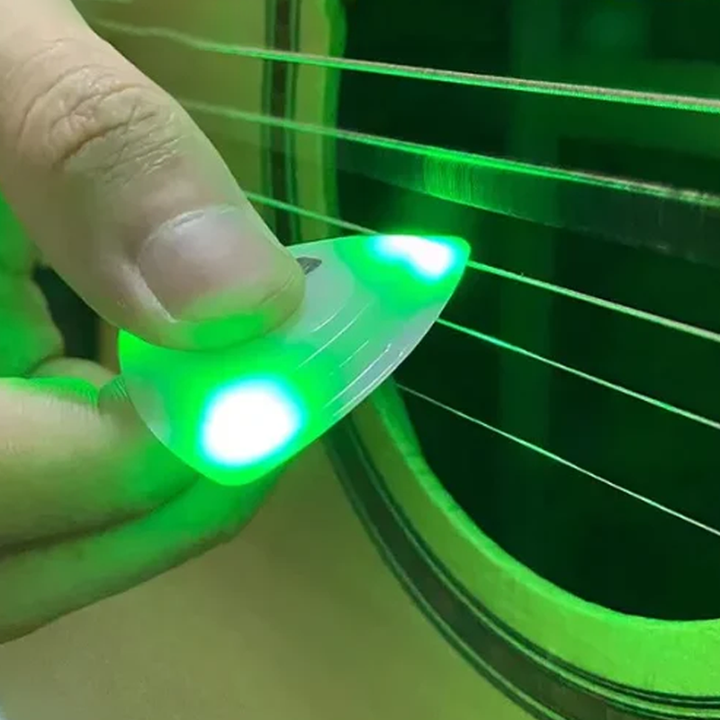 Guitarist using a Light Up Guitar Pick during a live performance, creating an engaging visual effect.