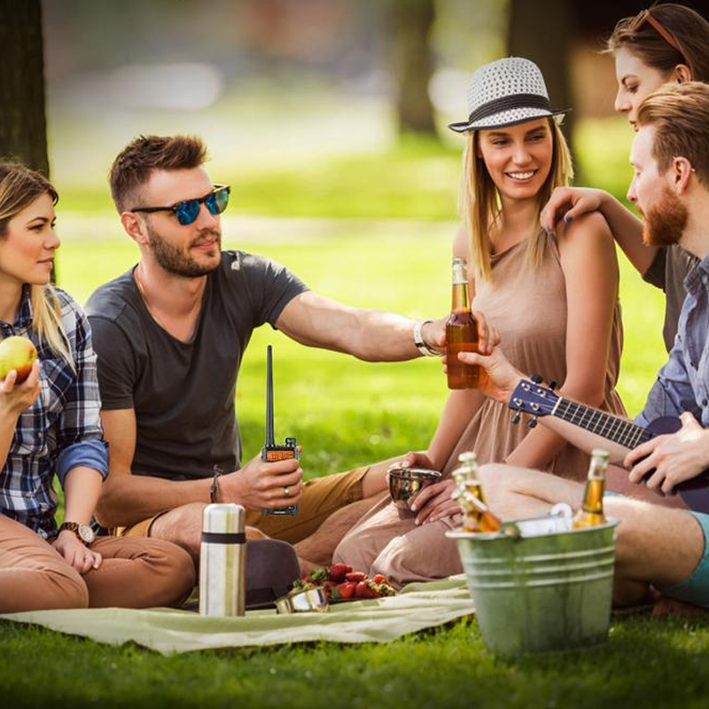Long range radio held in hand against an outdoor background, emphasizing portability