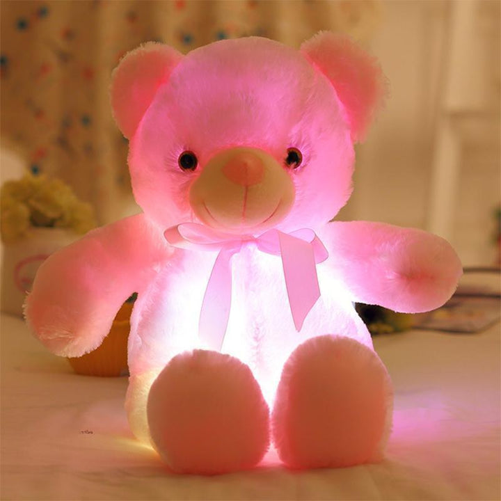 Child hugging a luminous LED teddy bear, illustrating its comfort as a cuddly, light up toy