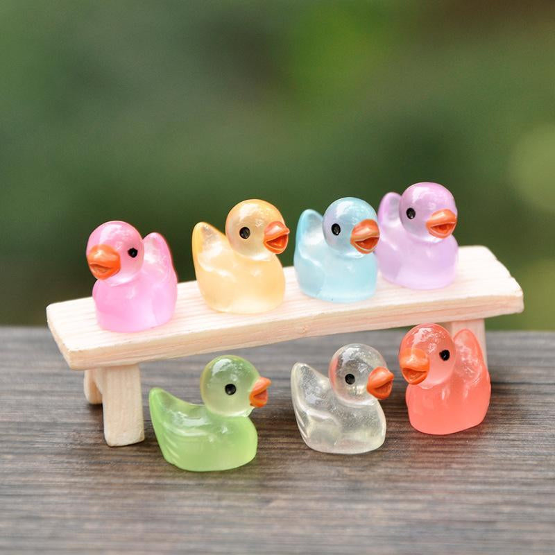 Assortment of luminous mini duck figurines, outdoor-ready, enhancing garden aesthetics at night.