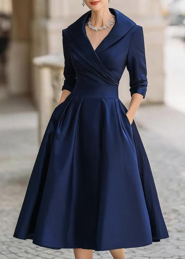 Sophisticated long-sleeve midi dress for women, featuring a draped neck and discreet side pockets.