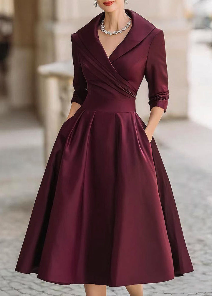 Elegant evening midi dress with a lustrous finish, draped neckline, and functional pockets.