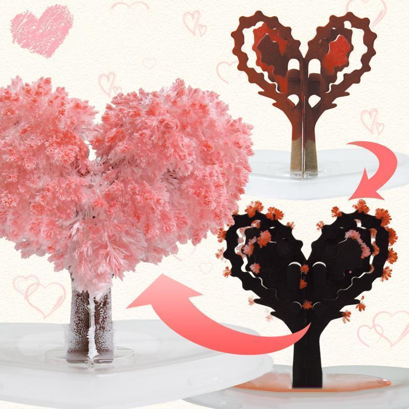 Hand holding a small, vibrant Magic Growing Crystal Tree, a charming novelty gift