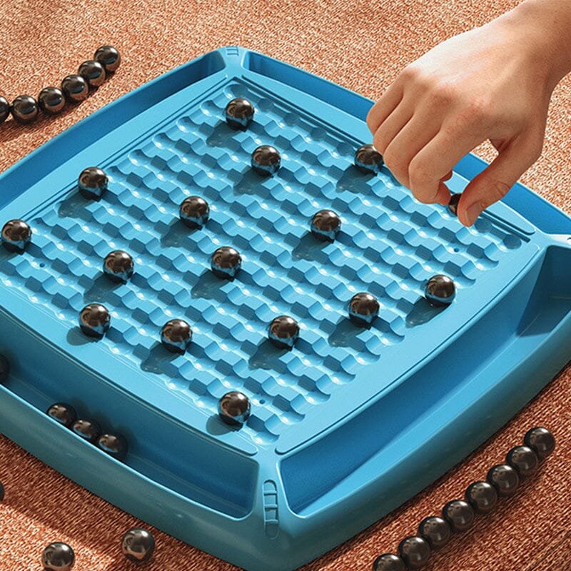 Two players focused on a game of Magnetic Attraction Chess, a fun and challenging strategy board game.