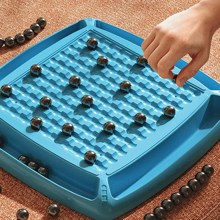 Two players focused on a game of Magnetic Attraction Chess, a fun and challenging strategy board game.