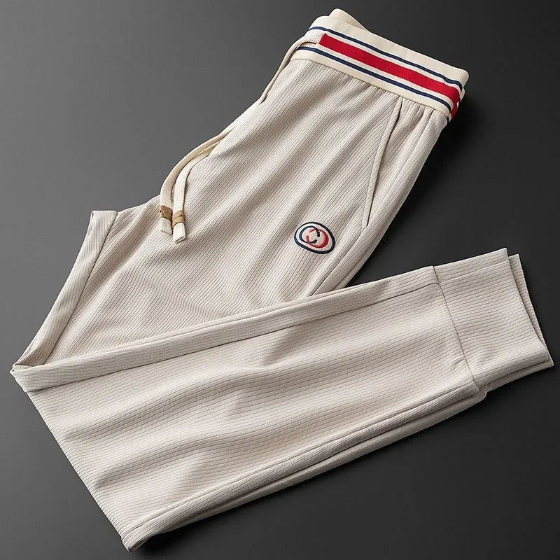 Comfortable men's jogger pants with a stylish striped waistband, ideal for athleisure & everyday wear.