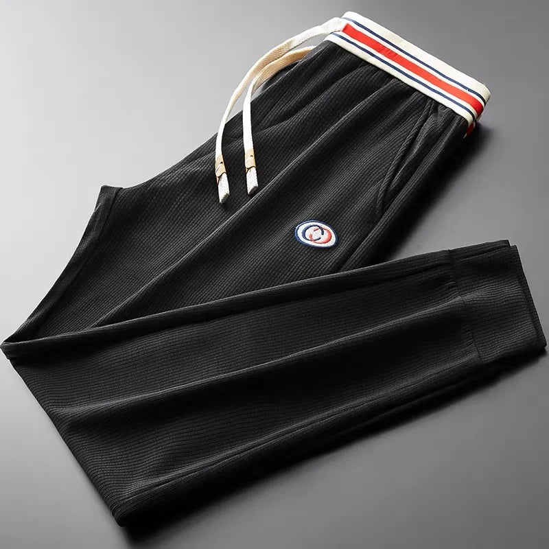 Black men's athletic pants, offering superior comfort & a modern tailored fit for active lifestyles.