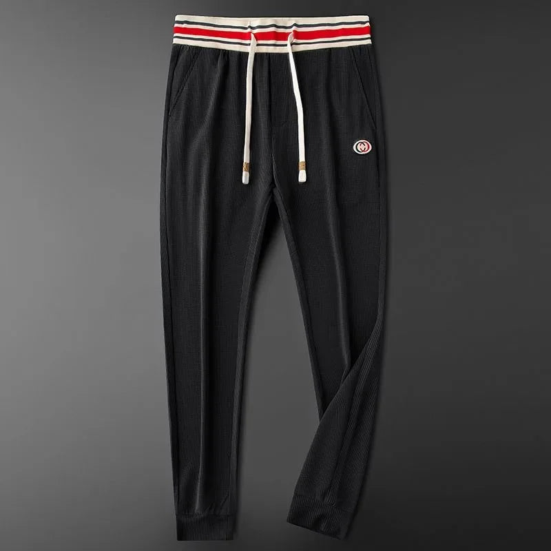 Tailored fit men's athletic joggers with a striped waistband, blending style & comfort for daily wear.