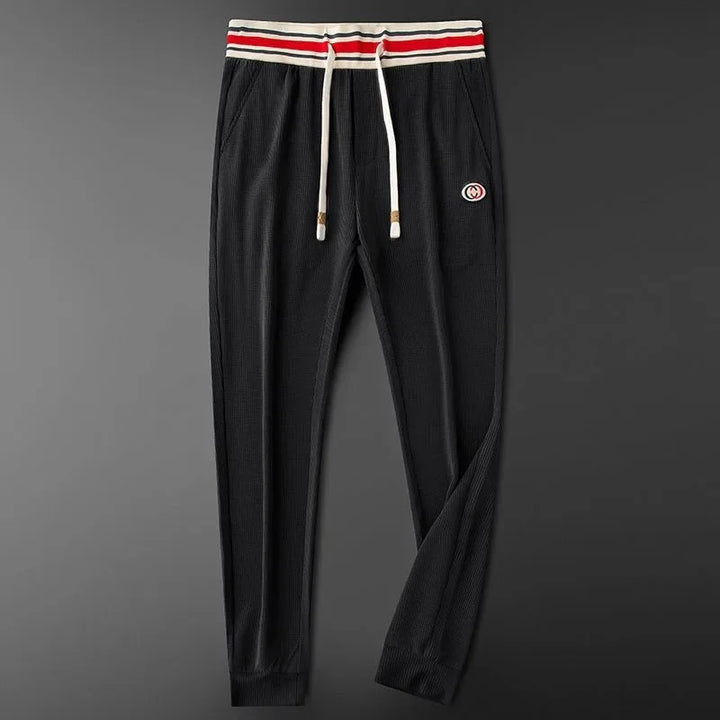 Tailored fit men's athletic joggers with a striped waistband, blending style & comfort for daily wear.