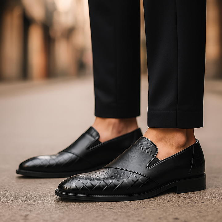 Men's formal black leather slip-on loafers with subtle croc-embossing for a refined look.