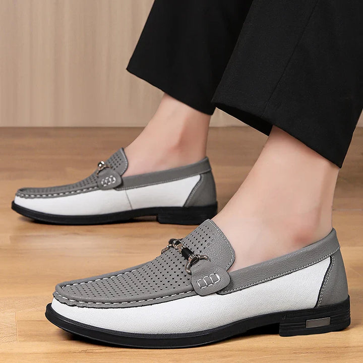 Front angle of men's black leather perforated loafers, polished look