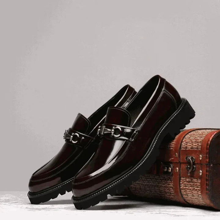 Close-up of polished leather texture on men's elegant dress loafers, emphasizing quality.