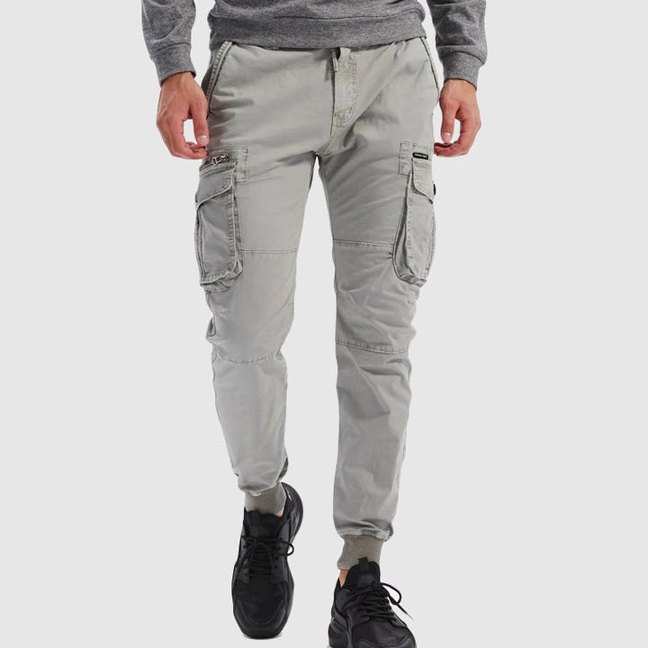 Durable men's tactical cargo pants with jogger cuffs, designed for outdoor adventure and urban casual fashion.