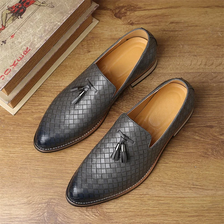Front view of men's textured loafers with prominent tassel accents, stylish and modern