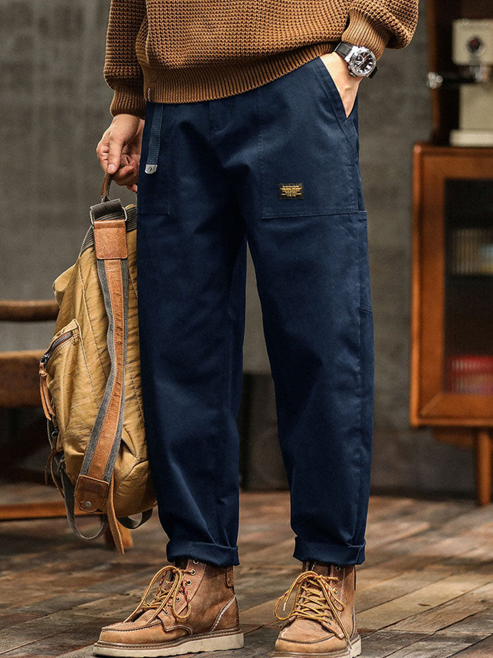 Men's black vintage utility pants with multi-pockets, durable for outdoor & casual wear.