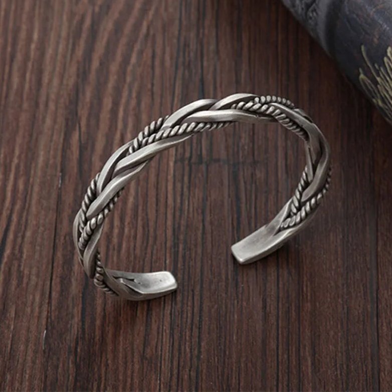 Handcrafted men's braided sterling silver cuff bracelet, an elegant and adjustable piece of silver jewelry.