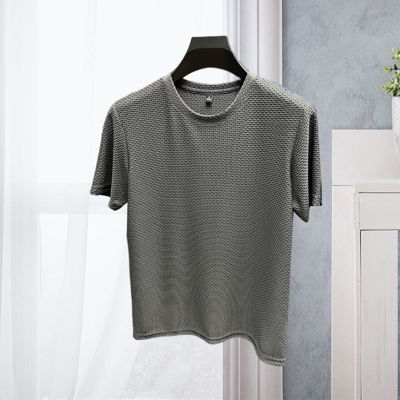 Flat lay of a men's ice silk short-sleeve t-shirt, showcasing the fabric and breathable mesh suitable for athletic or casual wear.