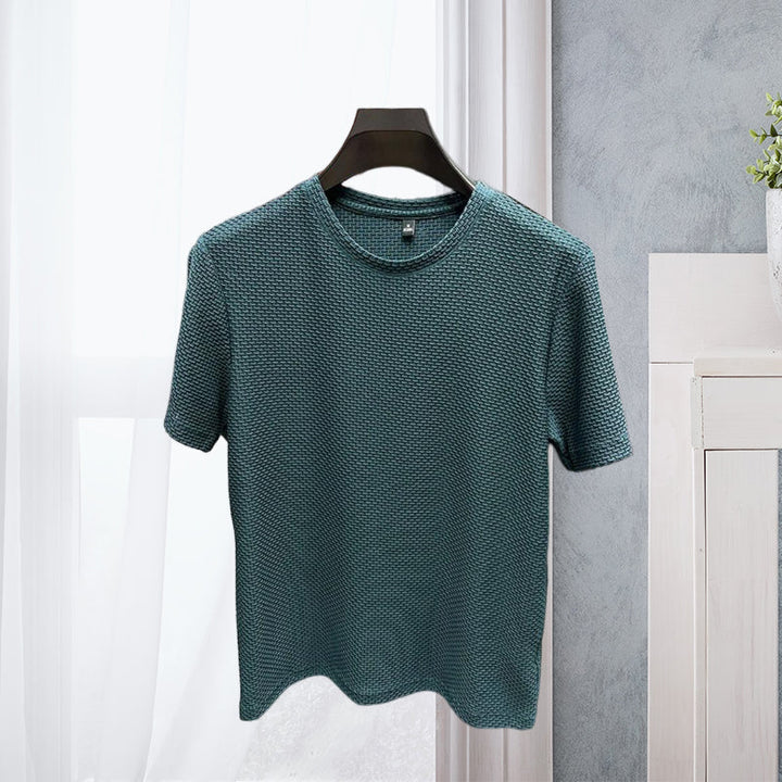 Folded men's short-sleeve ice silk t-shirt, emphasizing its compact and lightweight breathable design.