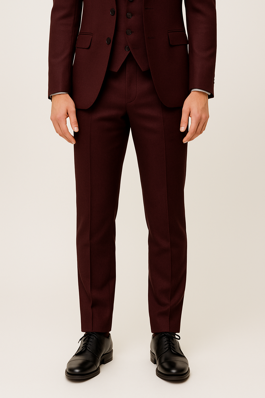 Full shot of a man wearing a burgundy spring/summer three-piece suit, elegant formal wear