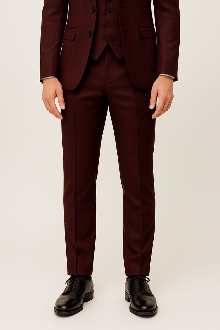 Full shot of a man wearing a burgundy spring/summer three-piece suit, elegant formal wear