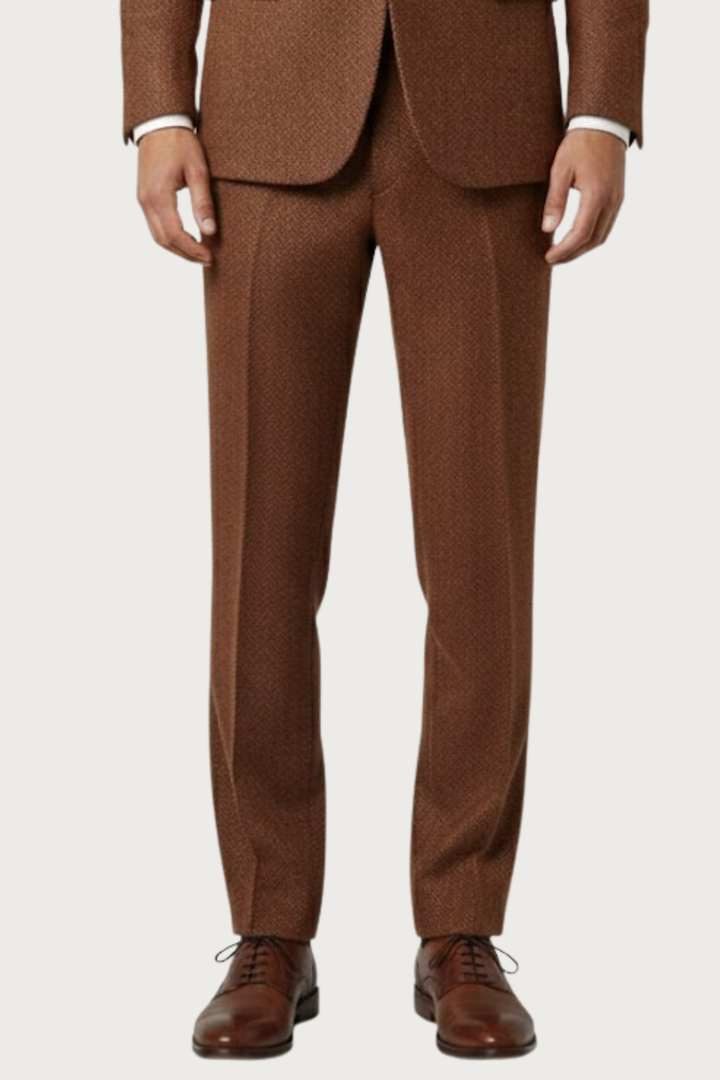 Elegant men's single-breasted burnt rust suit with vest, a versatile spring fashion statement for events.