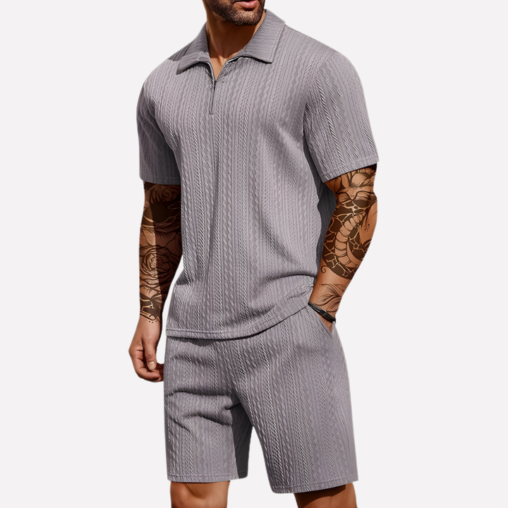 Casual men's two-piece set featuring a quarter-zip polo shirt and breathable shorts. Summer ready.