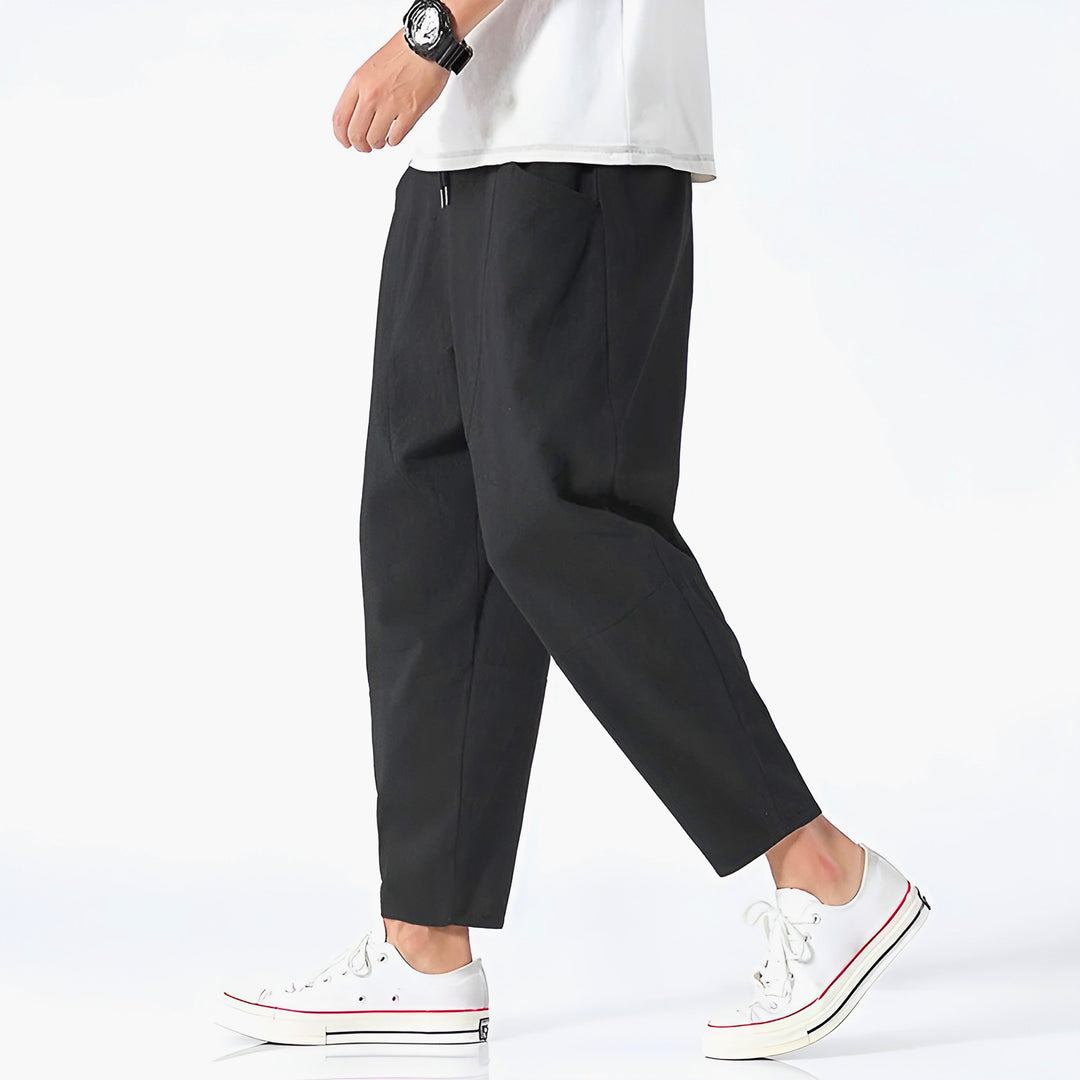 Man wearing relaxed fit cropped drawstring chino pants, showcasing casual fashion.