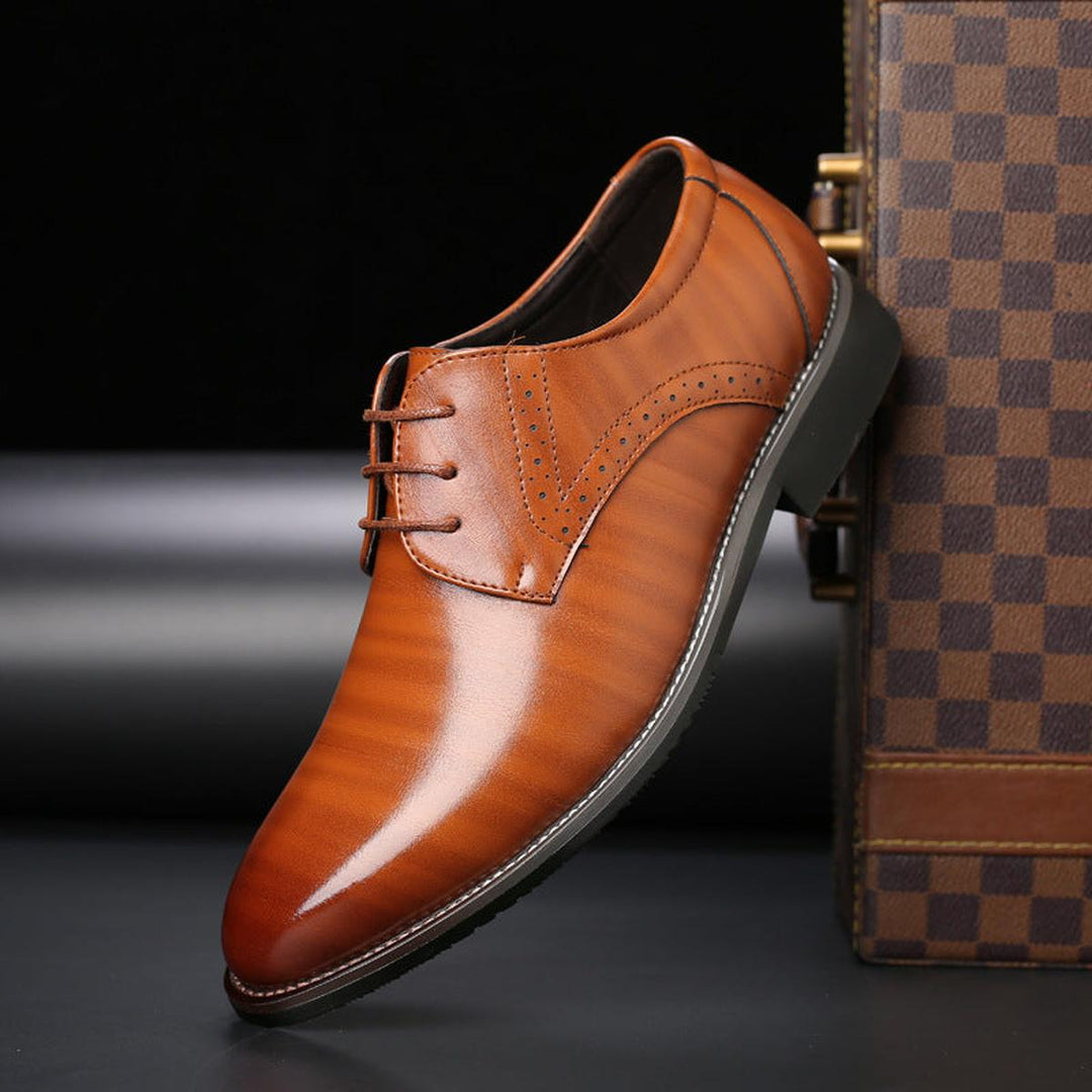 Elegant men's classic lace-up dress shoes in a dark finish, ideal for professional and event wear.