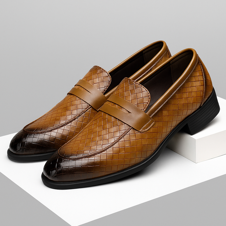 Pair of black men's woven leather penny loafers from above, classic style, comfortable