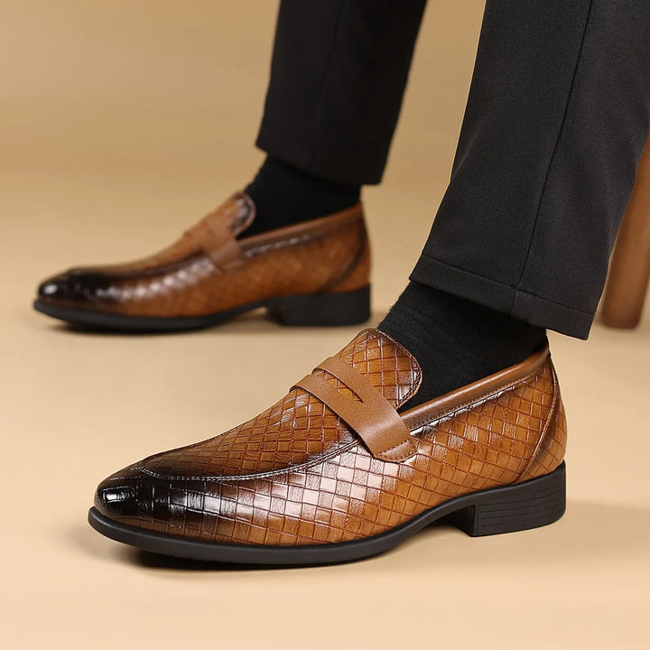 Men's black woven leather penny loafers, worn on foot, showcasing classic style and comfort