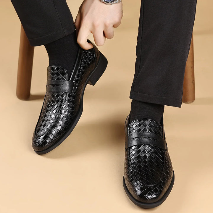Detailed front view of men's dark brown woven leather penny loafers with penny slot