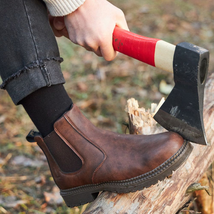 Side profile of men's brown comfort fit leather Chelsea boot with durable sole, ideal for men's footwear