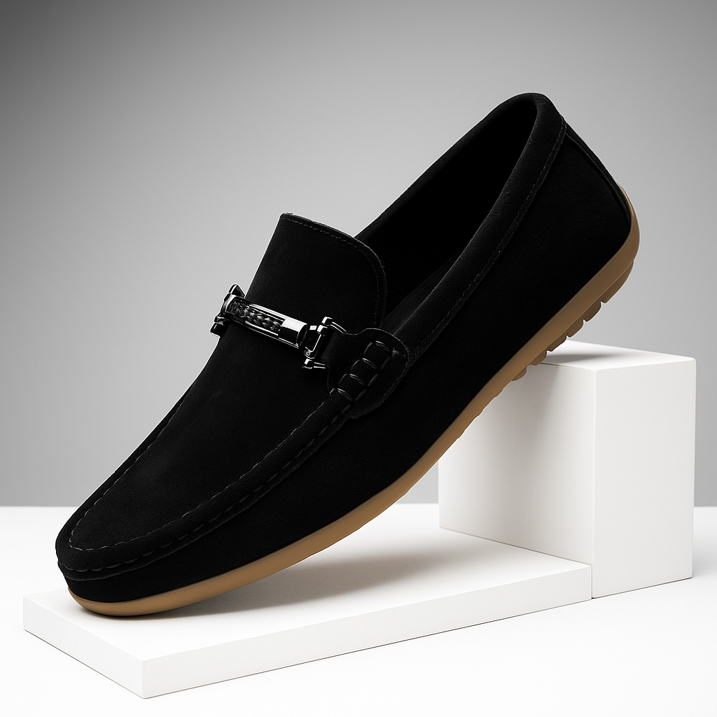 Pair of black men's suede slip-on loafers, showcasing the sleek profile and cozy interior