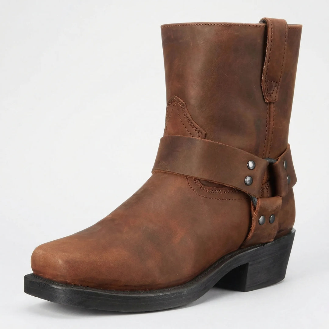 Rugged men's western boots with studded strap. Classic slip-on cowboy style offering versatile comfort.