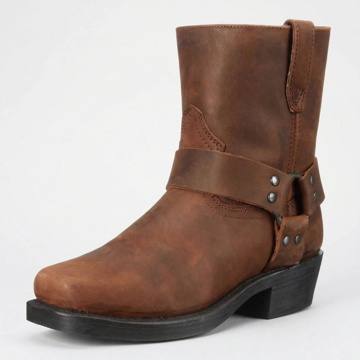 Rugged men's western boots with studded strap. Classic slip-on cowboy style offering versatile comfort.