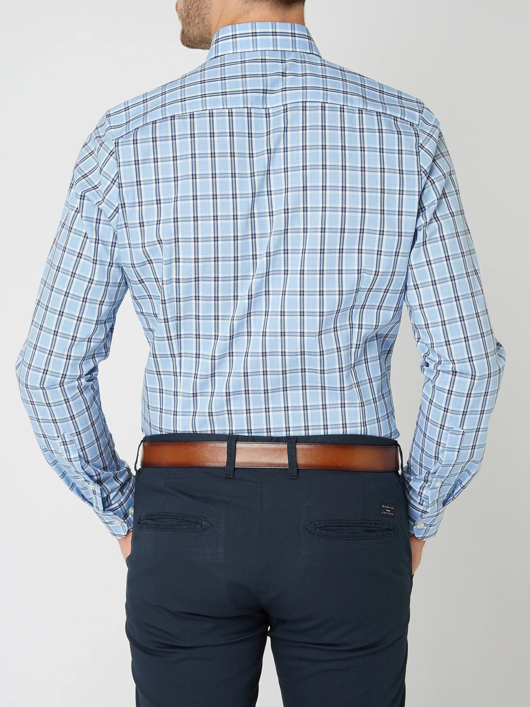 Flat lay of a men's classic plaid long-sleeve shirt, showcasing its durable button-down design.